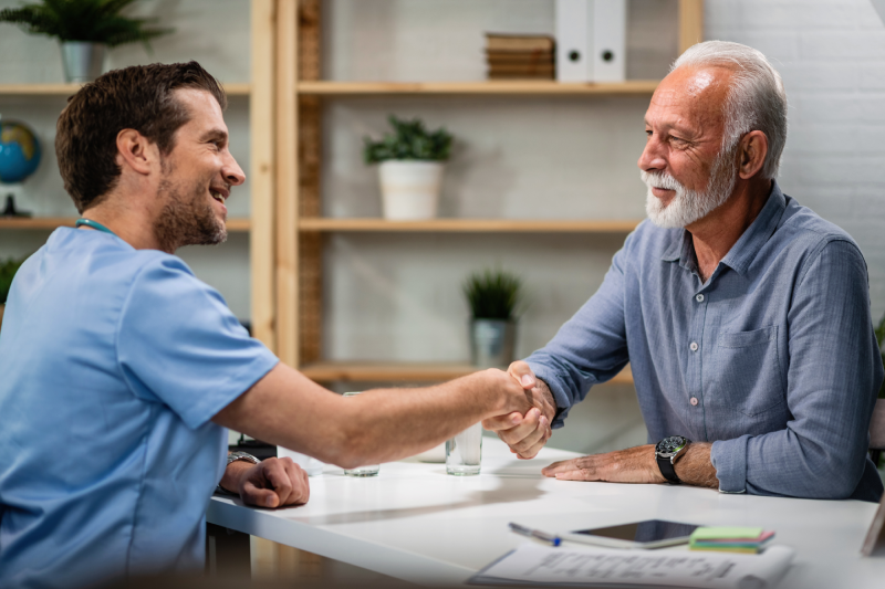 happy-doctor-greeting-handshaking-with-senior-patient-his-office-focus-is-senior-man happy-doctor-greeting-handshaking-with-senior-patient-his-office-focus-is-senior-man